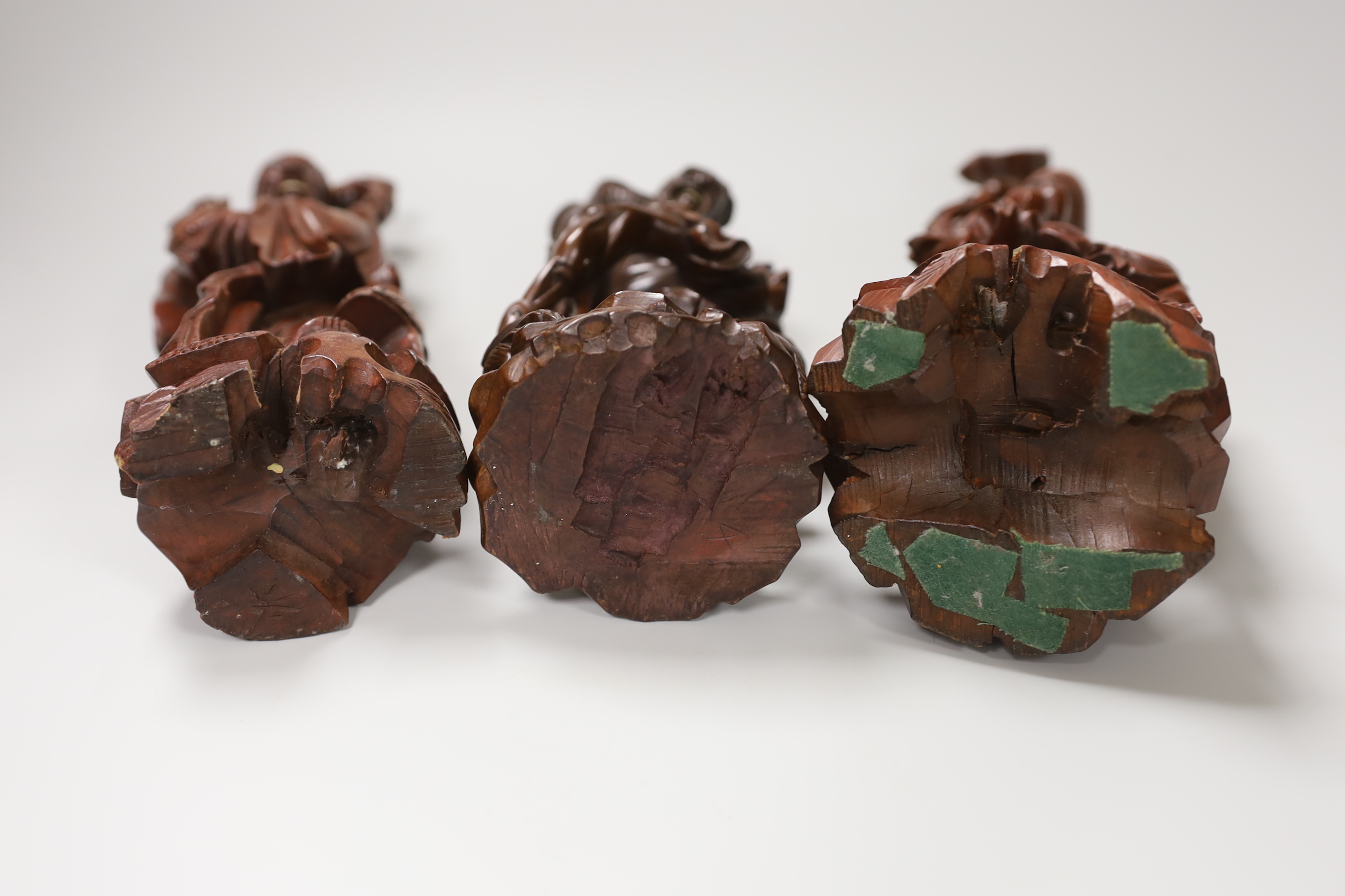 Three Chinese carved wood figures of Shou Lao and a fisherman, the largest 25cm high